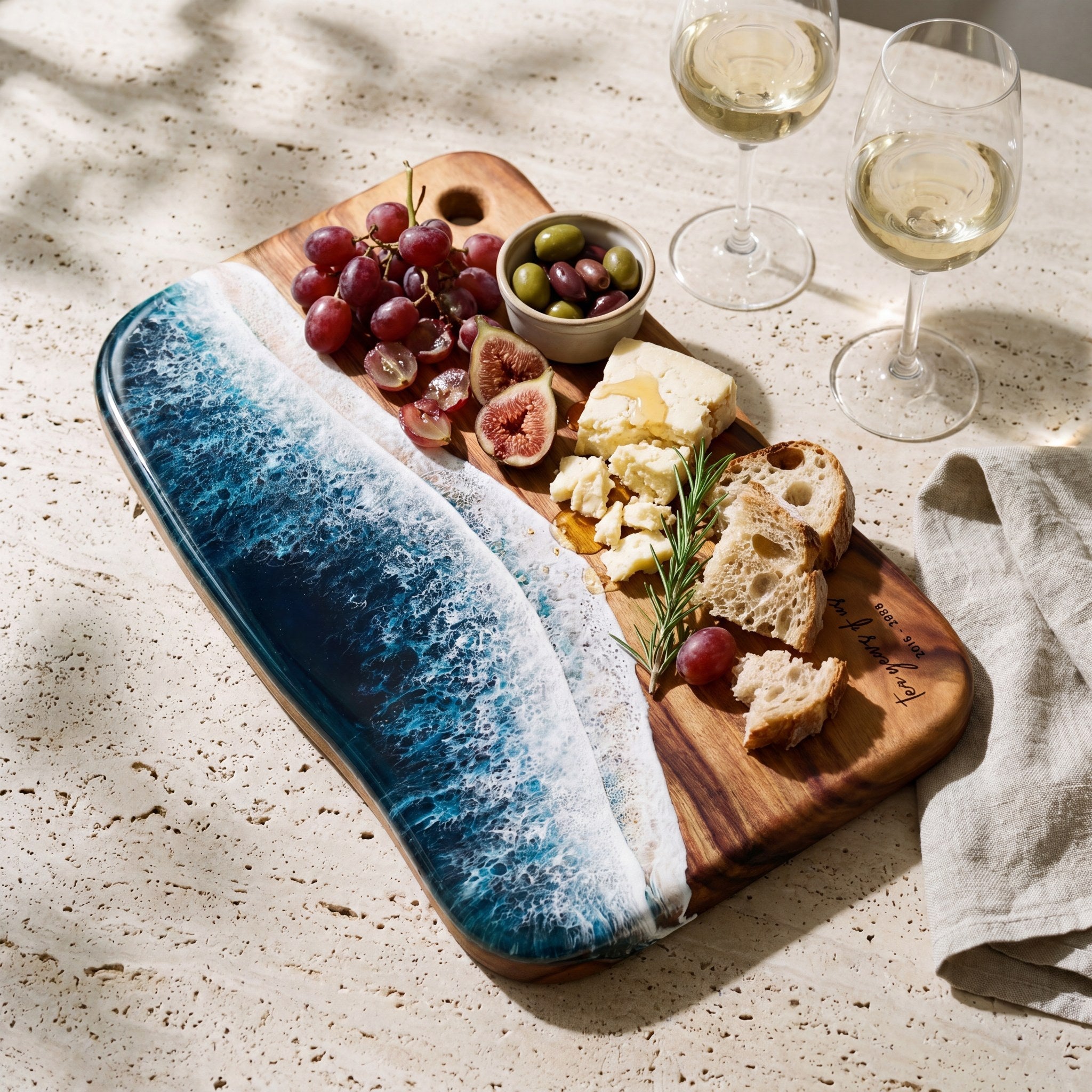 A personalised resin and Camphor Laurel grazing board styled for an anniversary