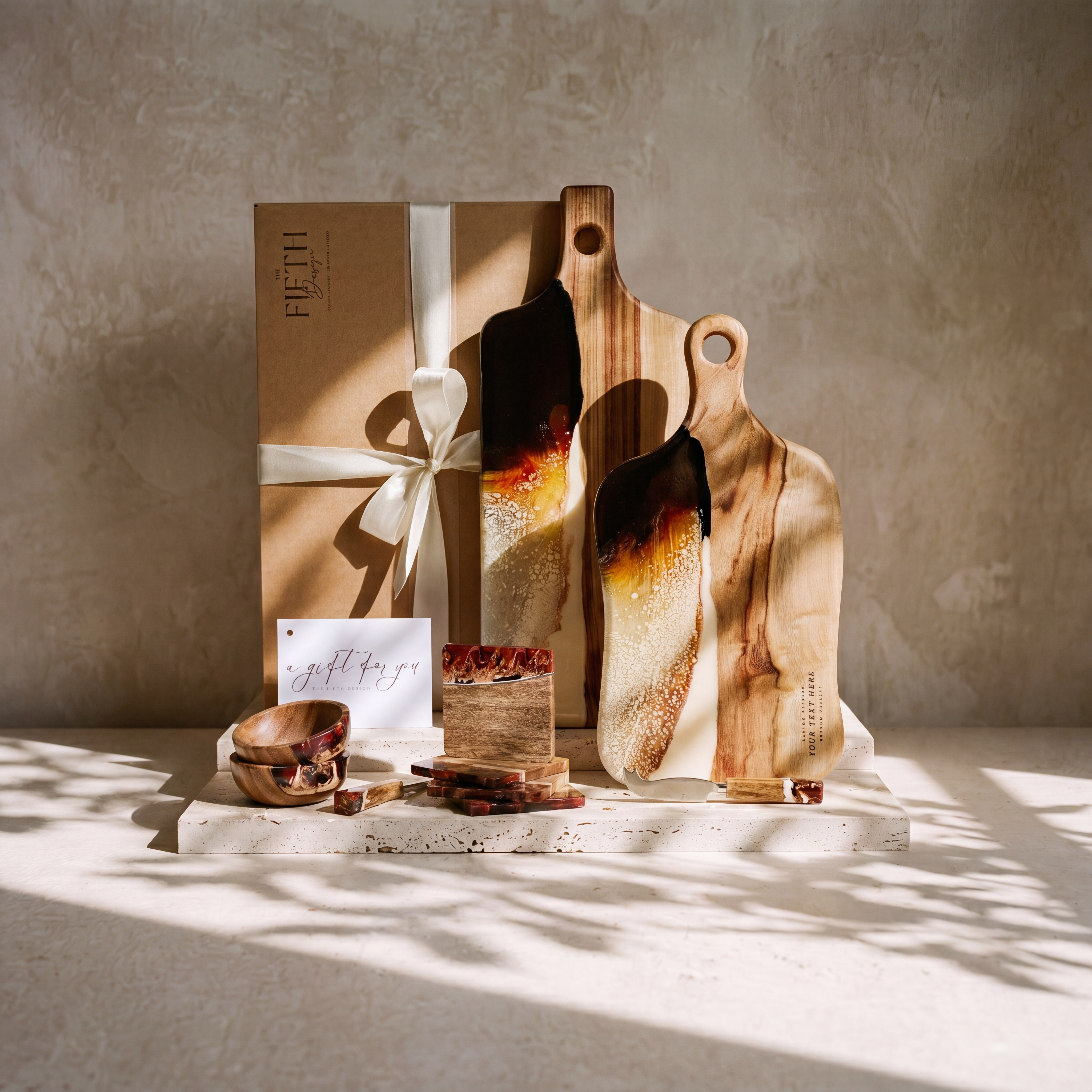 The Entertainer's Bundle in Burnt Ivory - styled lifestyle hero, bundle arranged on travertine in warm editorial light