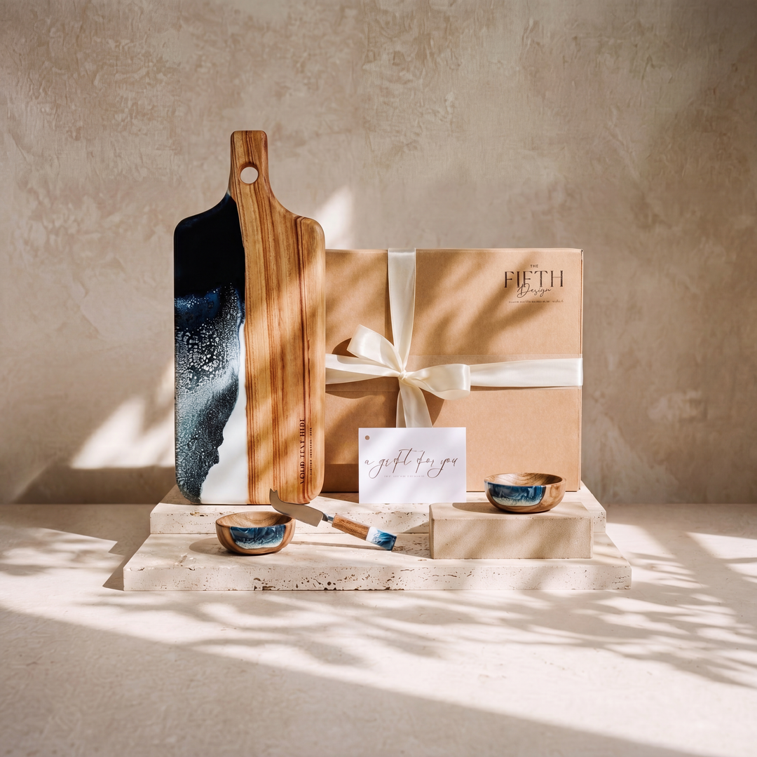 The Ultimate Gift Bundle in Prussian Blue - styled lifestyle hero, bundle arranged on travertine in warm editorial light