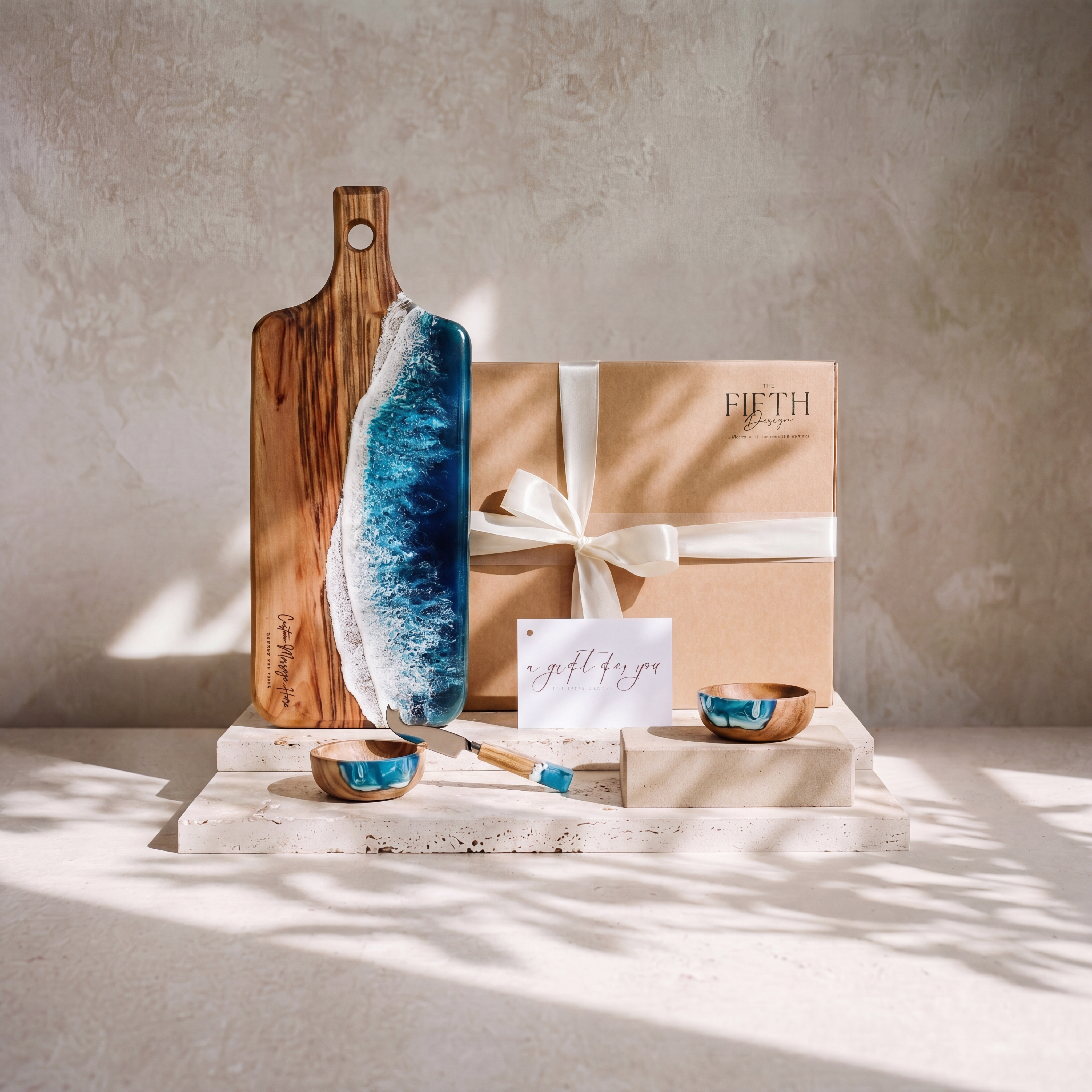 The Ultimate Gift Bundle in Seascape - styled lifestyle hero, bundle arranged on travertine in warm editorial light