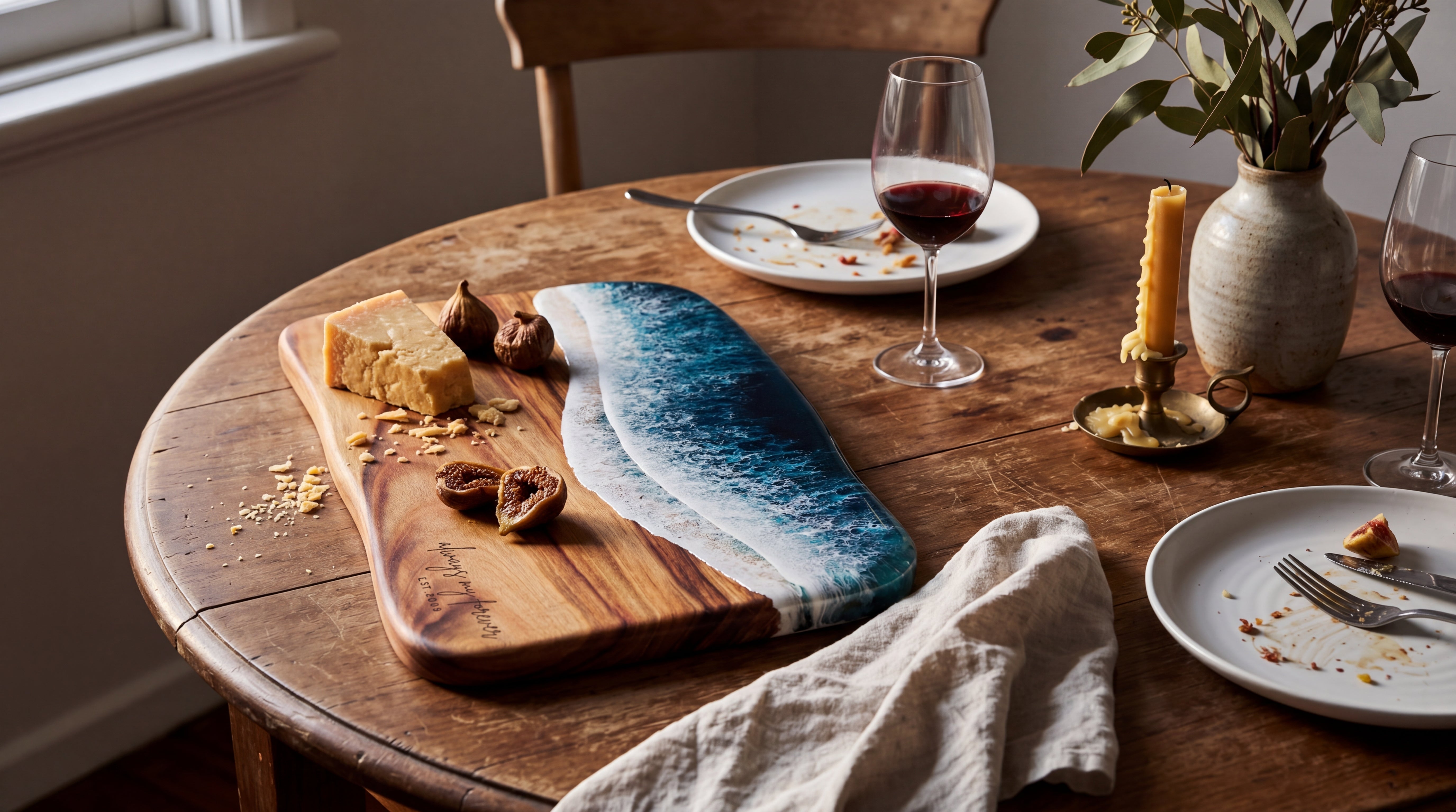 Anniversary dinner with Round Paddle Seascape, linen tablecloth, eucalyptus, candlelight