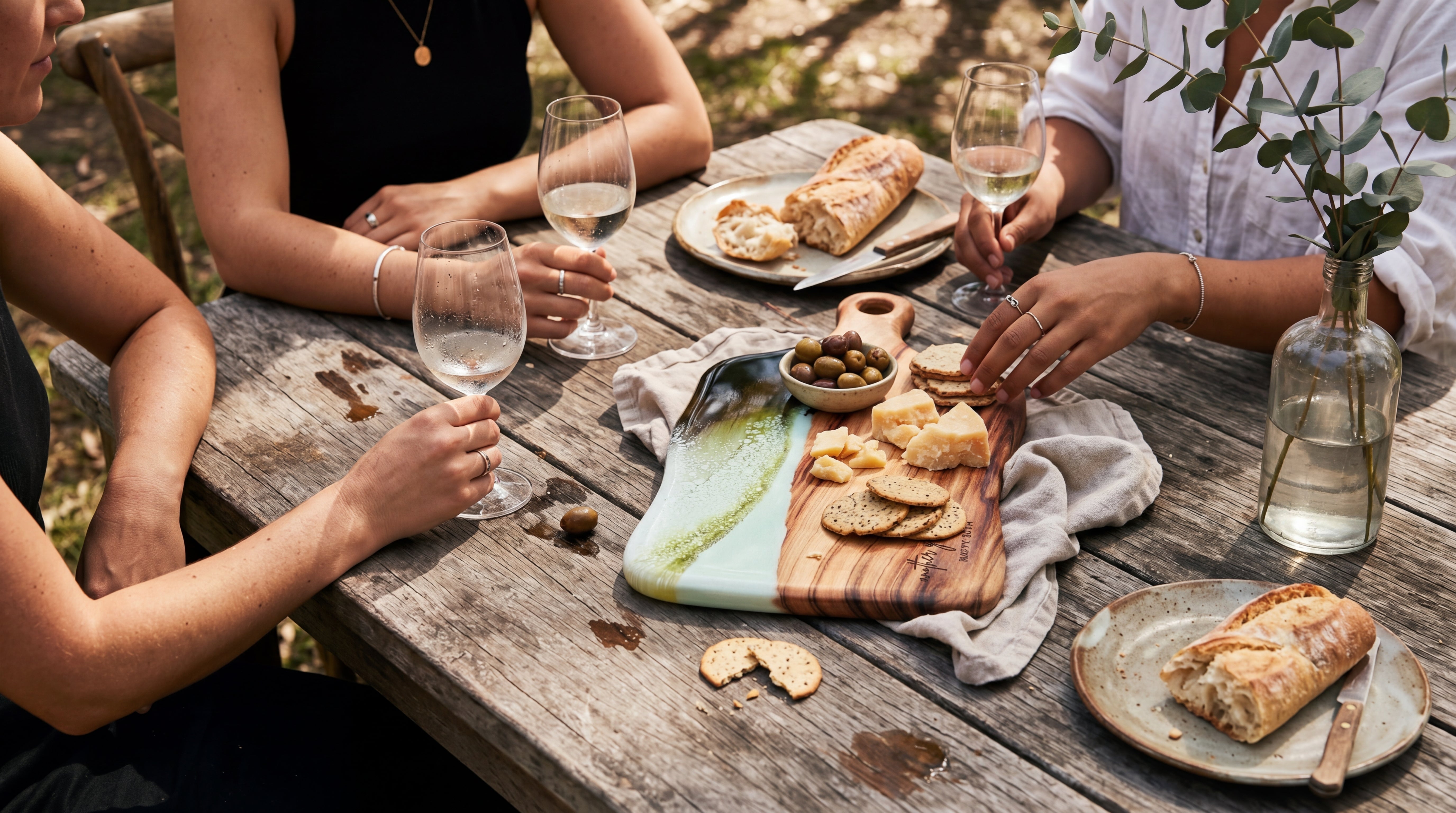Lexicon hero — outdoor anniversary gathering with engraved cheese board