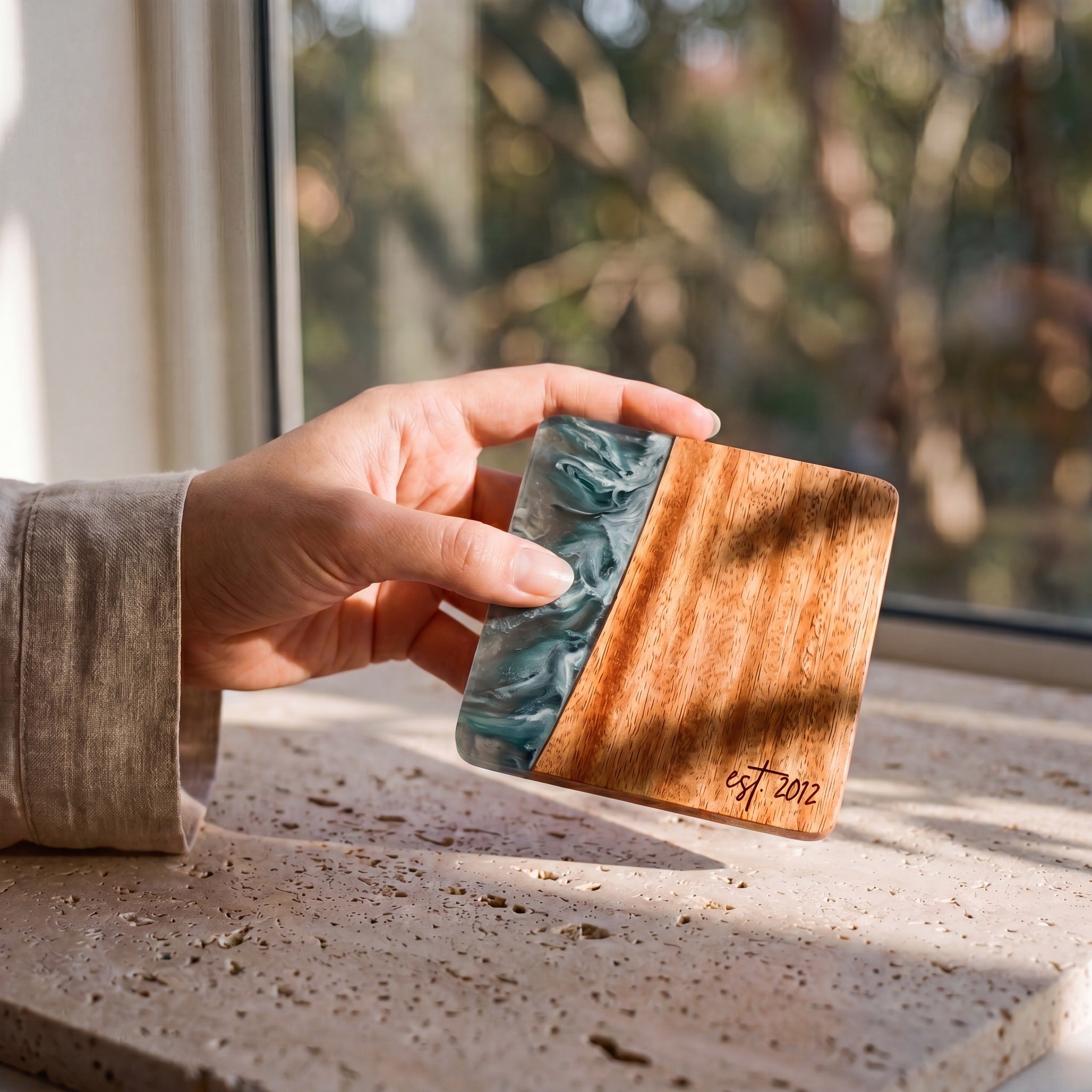 Slate resin and wood coaster held in hand