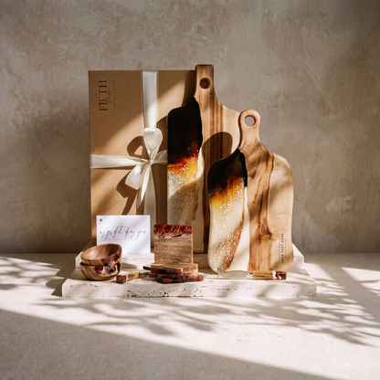 The Entertainer's Bundle in Burnt Ivory - styled lifestyle hero, bundle arranged on travertine in warm editorial light