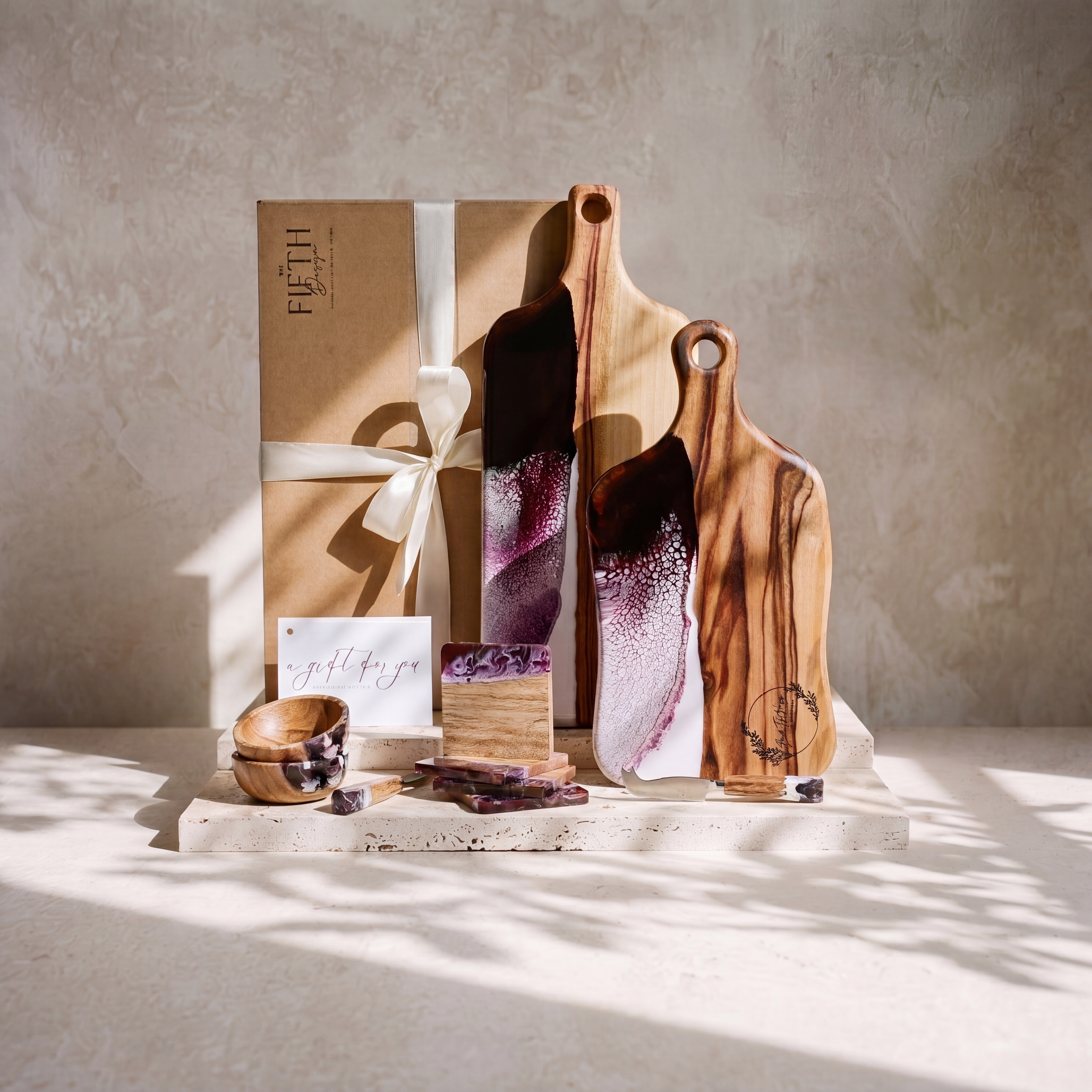 The Entertainer's Bundle in Lilac - styled lifestyle hero, bundle arranged on travertine in warm editorial light