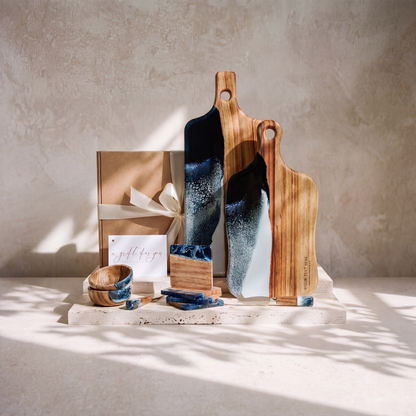 The Entertainer's Bundle in Prussian Blue - styled lifestyle hero, bundle arranged on travertine in warm editorial light