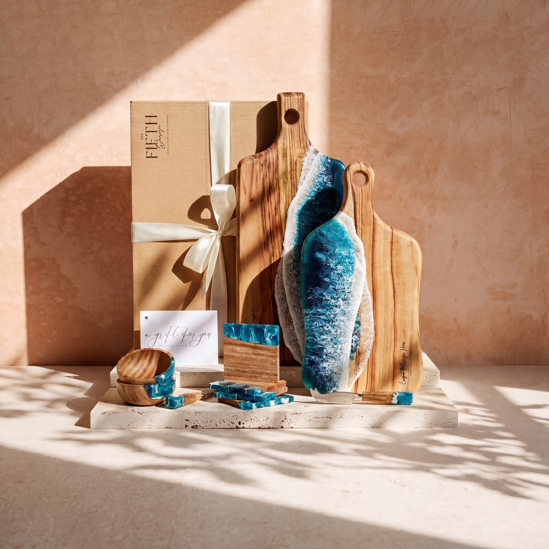 The Entertainer's Bundle in Seascape - styled lifestyle hero, bundle arranged on travertine in warm editorial light