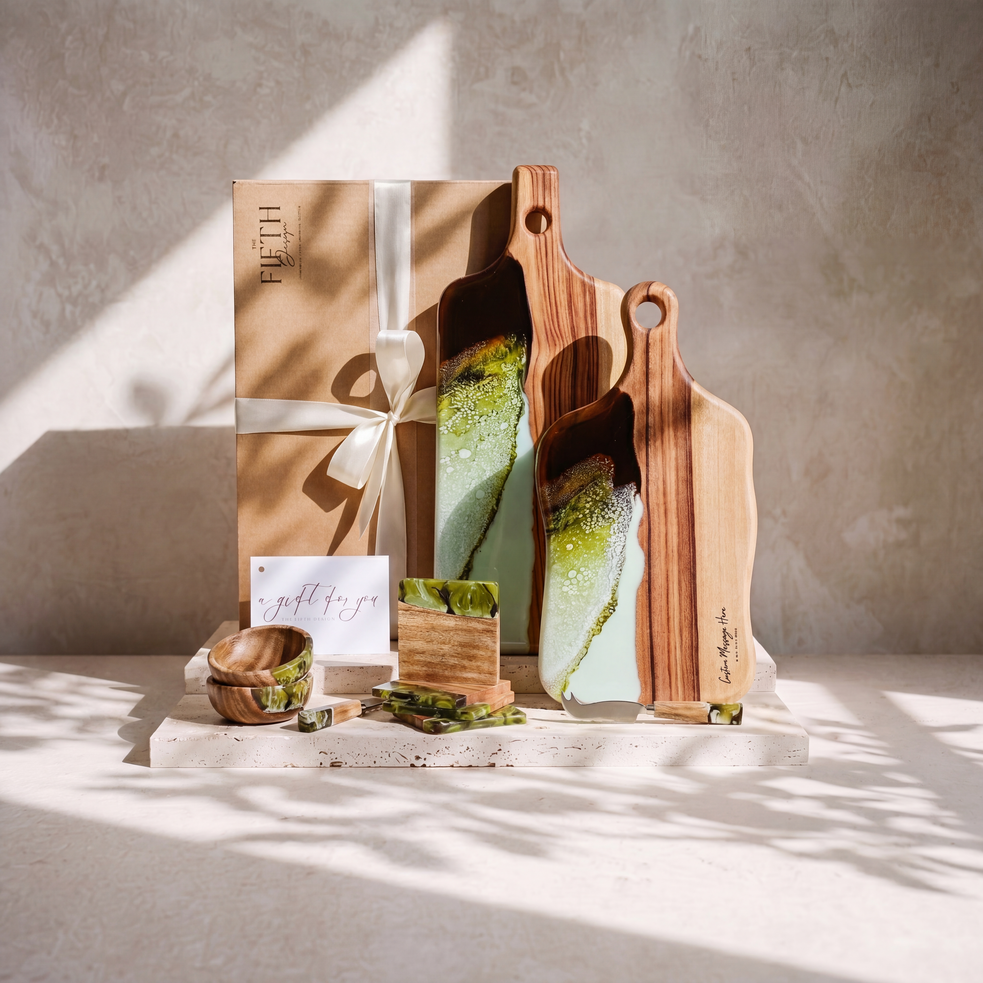 The Entertainer's Bundle in Sage Green - styled lifestyle hero, bundle arranged on travertine in warm editorial light