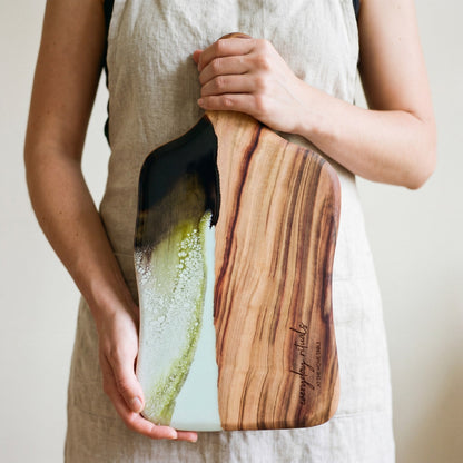 The Entertainer's Bundle in Sage Green - Medium paddle held in hand for scale