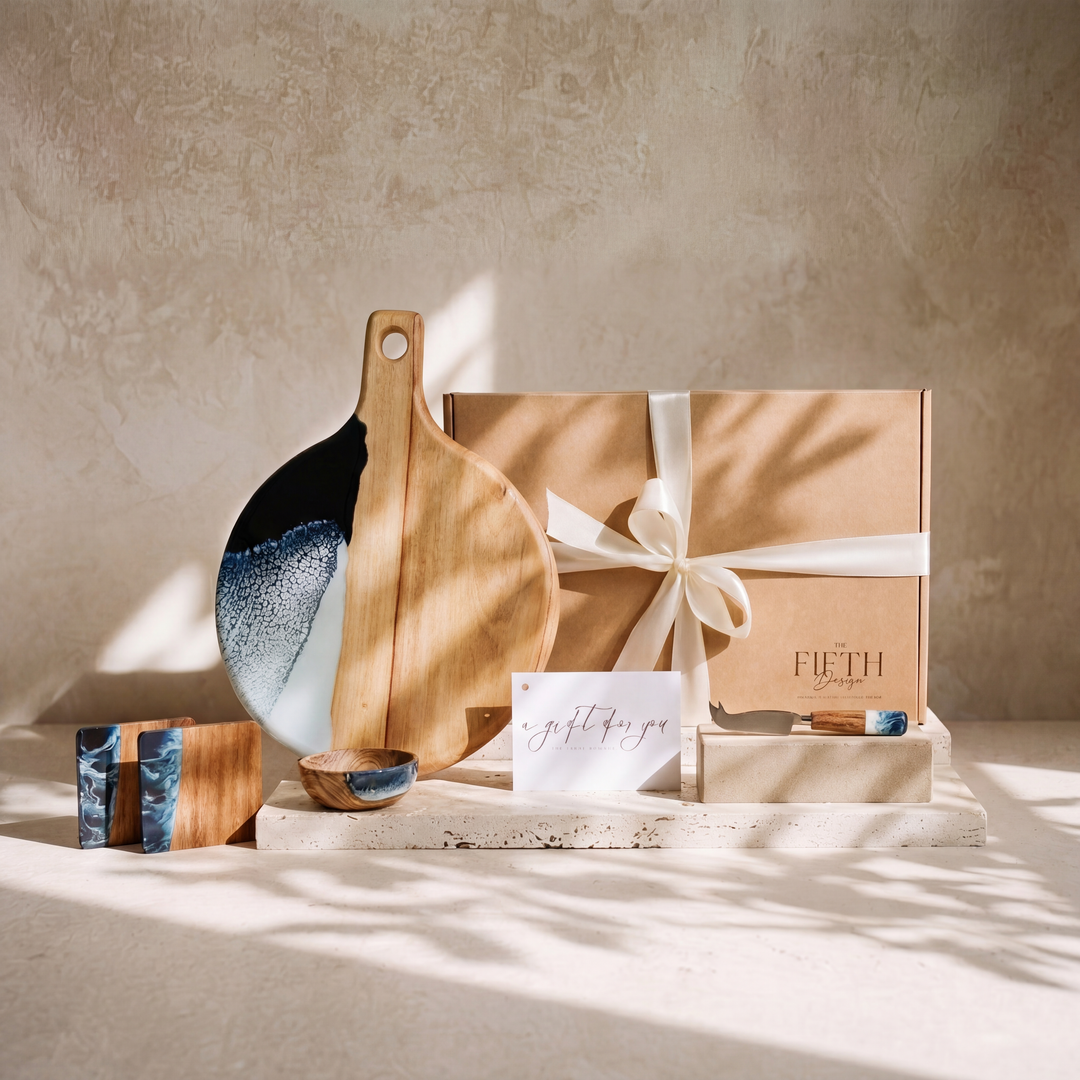 The Grazing Gift Box in Prussian Blue - styled lifestyle hero, bundle arranged on travertine in warm editorial light