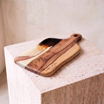 Medium Resin Paddle Board in Burnt Ivory - Hero shot on travertine plinth #colour_burnt-ivory