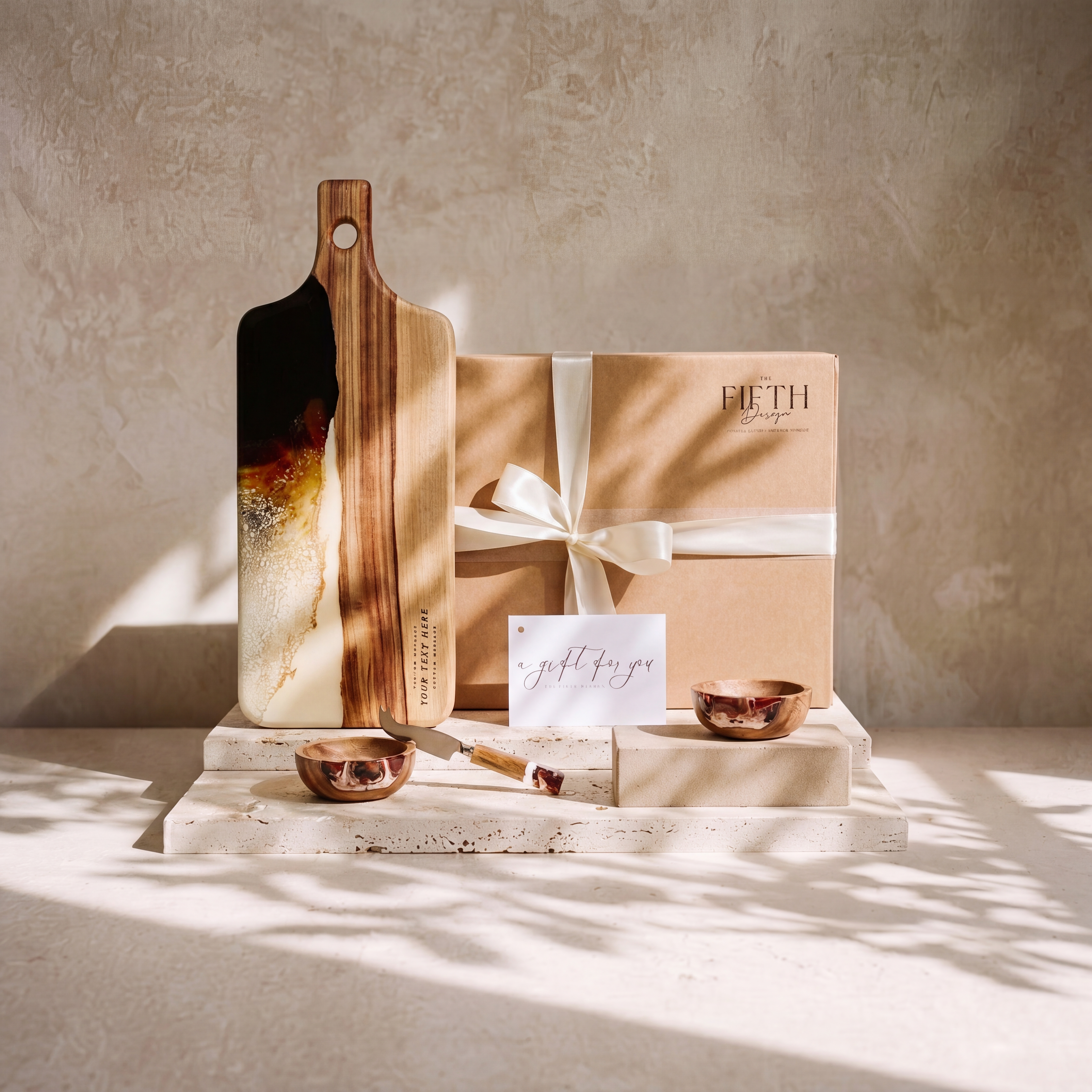 The Ultimate Gift Bundle in Burnt Ivory - styled lifestyle hero, bundle arranged on travertine in warm editorial light