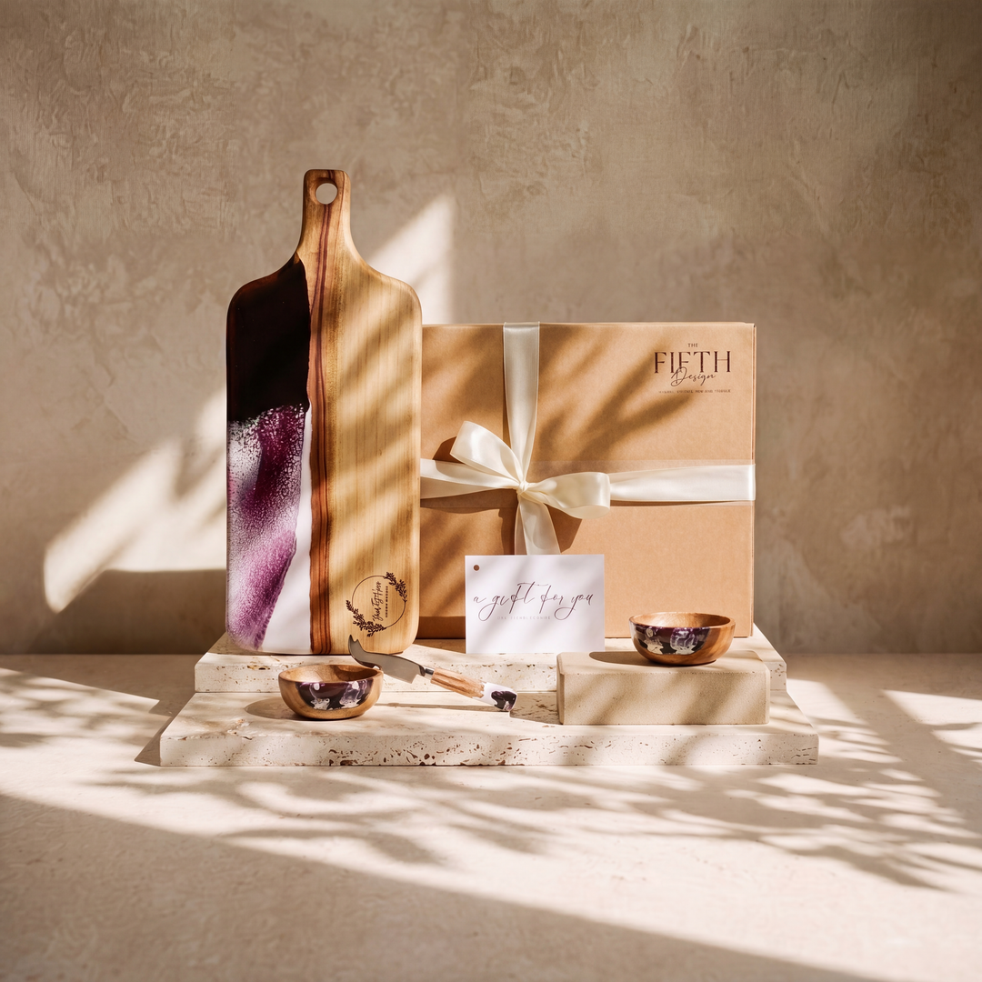 The Ultimate Gift Bundle in Lilac - styled lifestyle hero, bundle arranged on travertine in warm editorial light