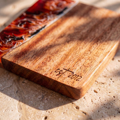 Burnt Ivory engraving detail on a resin and wood coaster