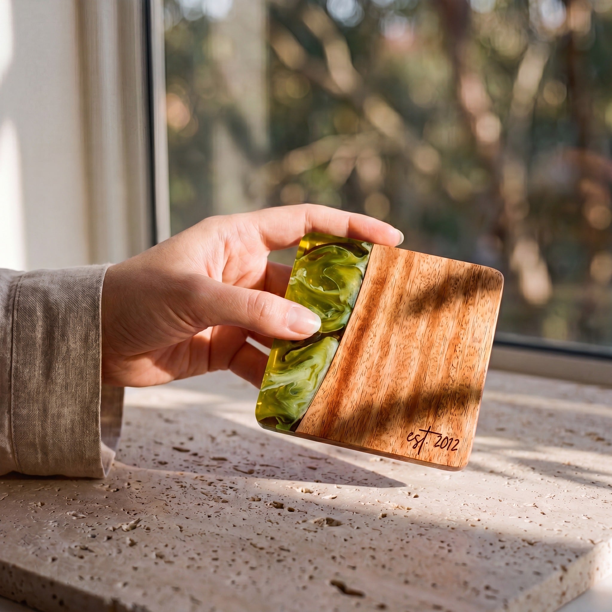 Sage Green resin and wood coaster held in hand