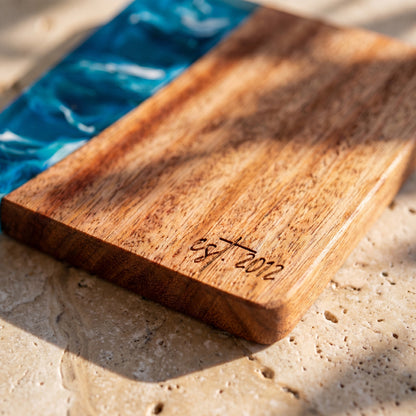 Seascape engraving detail on a resin and wood coaster